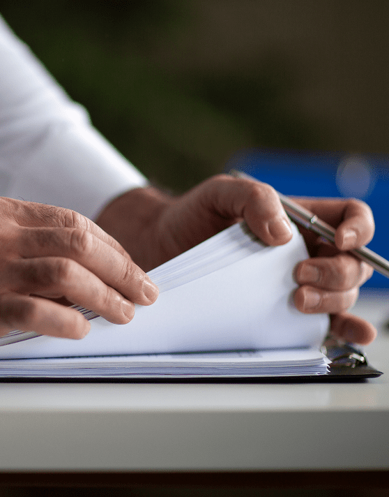 Person reviewing documents with pen